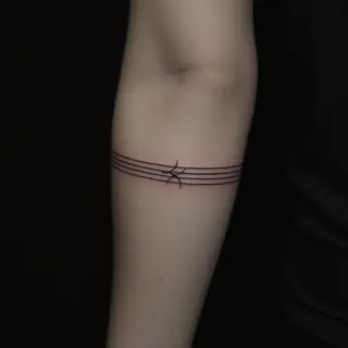 The Subtle Meaning of a 2-Line Armband Tattoo