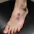 Korean Letter Tattoos: Minimalist Foot Designs in Pink