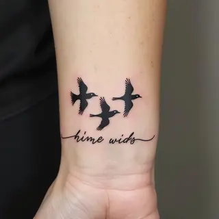 Delicate Birds and Script Wrist Tattoo: A Symbol of Freedom